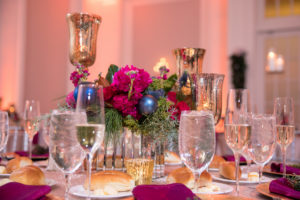 Wedding reception centerpiece with hot pink flowers